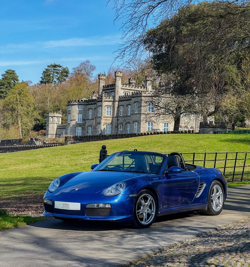 Blue Porche parked up in front of Bolesworth Castle