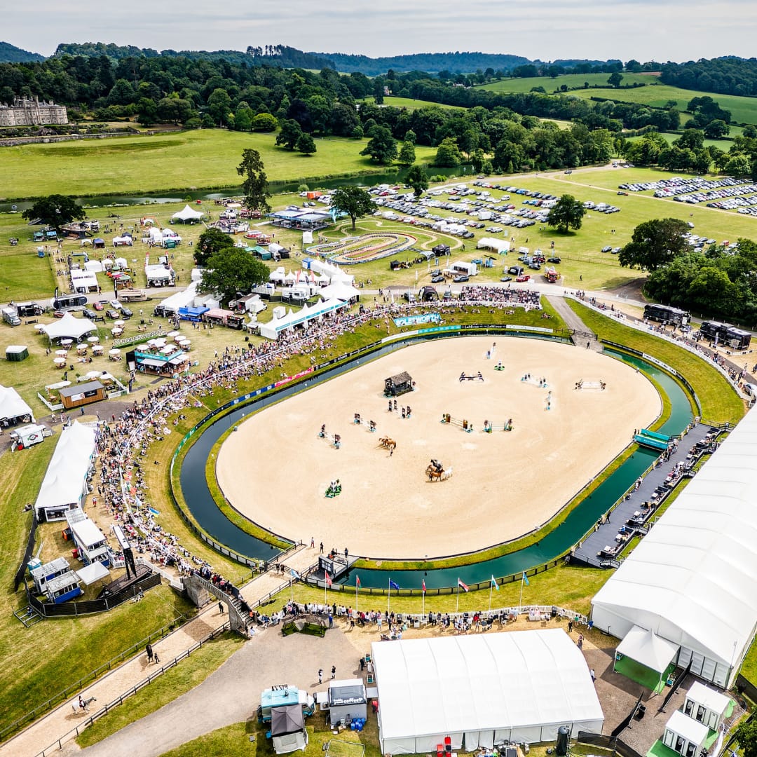Aerial view of the Bolesworth grounds during the international event, showcasing trade stands, show grounds, hospitality tents, large crowds, parking areas, and the Bolesworth estate.