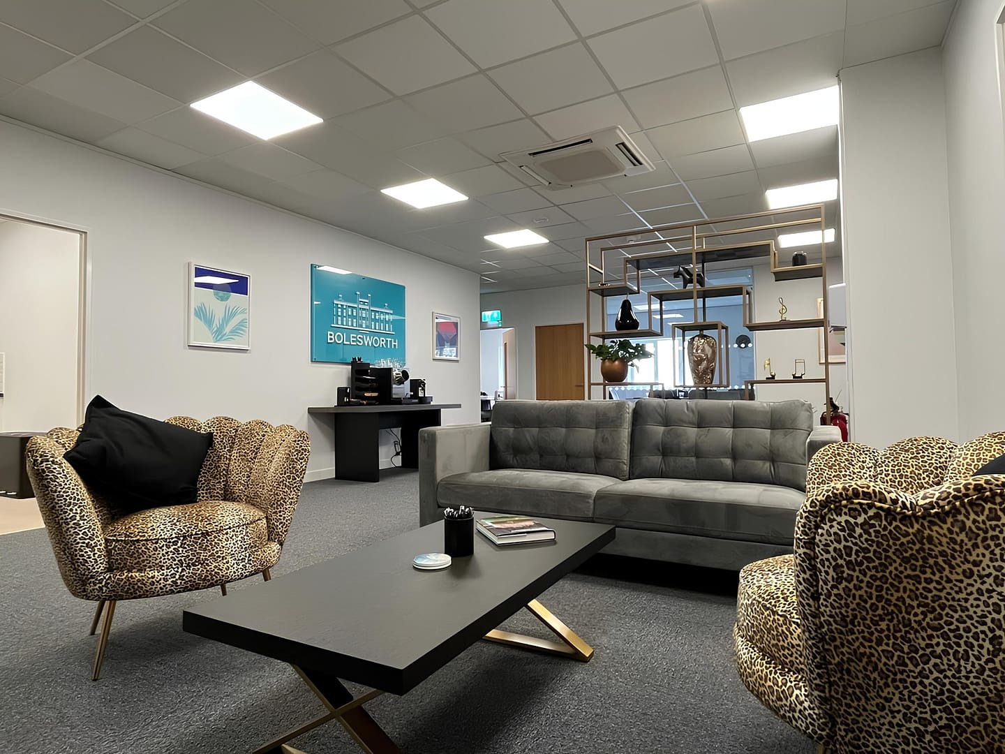 Interior view of a modern seating area at the Grainstore, featuring comfortable seating, a coffee table, and decor elements in a bright, well-lit space.