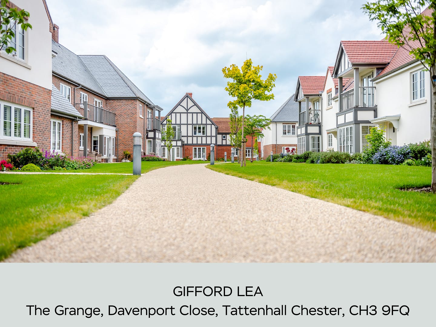 A picturesque view of Olympus House at Gifford Lea, a premium retirement village in Tattenhall, Chester (CH3 9FQ). The image showcases beautifully landscaped gardens, modern Tudor-style and red-brick homes, and a peaceful walkway leading through the vibrant community. Ideal for independent living with luxury amenities.