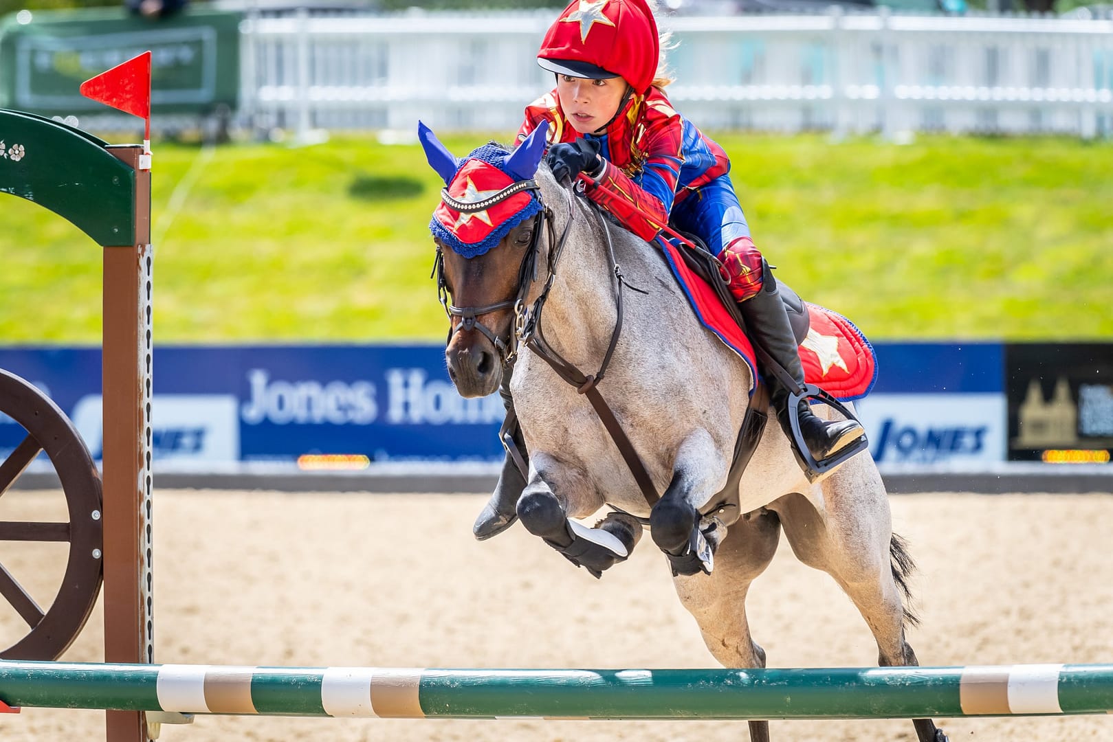 A little girl dressed up as a superhero for the family friendly experience day 'Finale Day' a fancy dress equestrian event.
