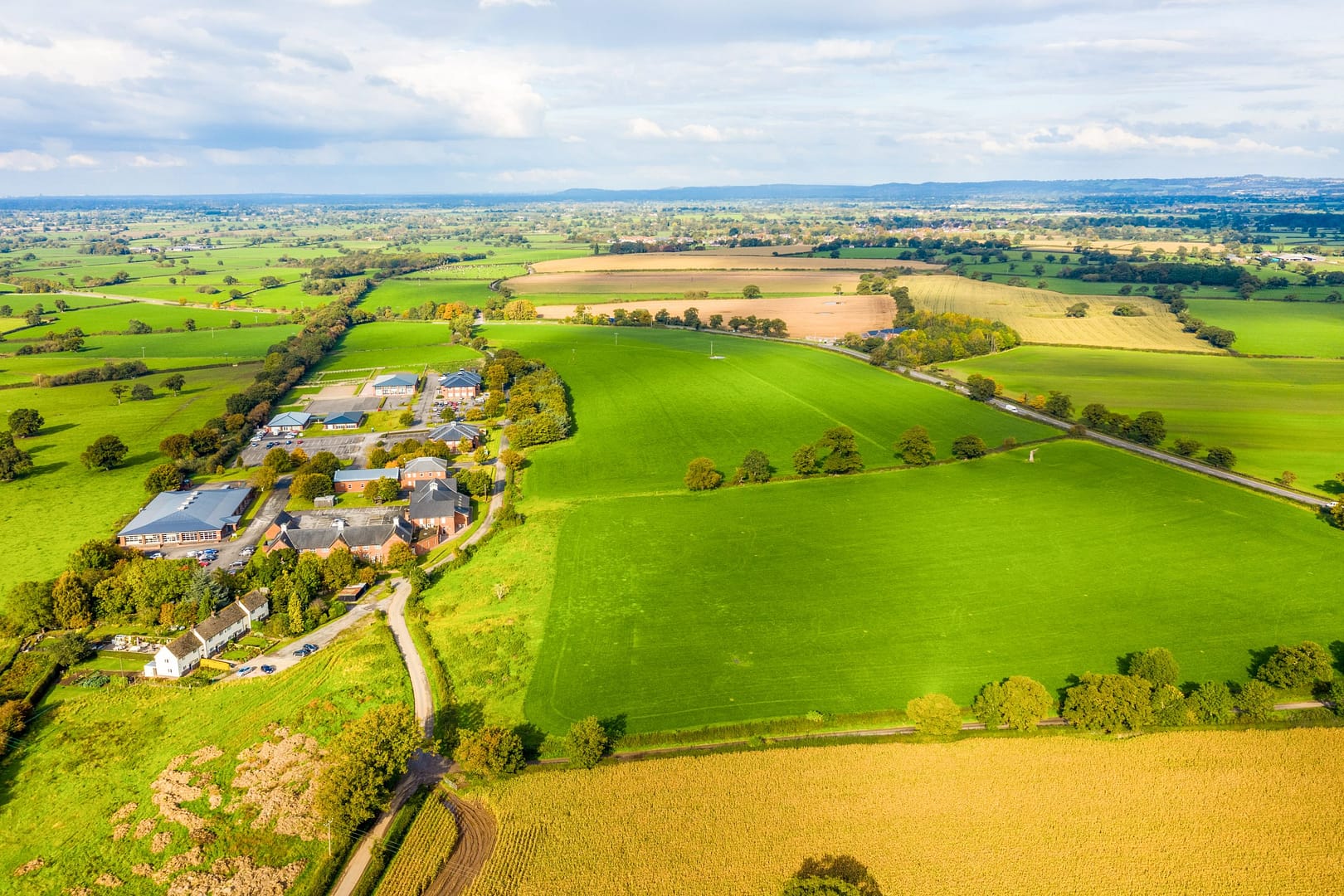 Aerial view of Bolesworth Estate showcasing rural business grounds and properties surrounded by lush countryside.