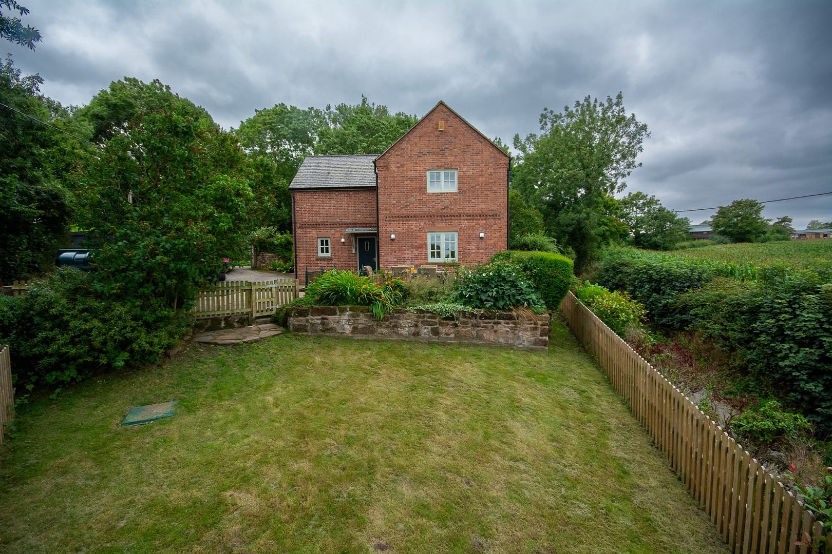 Detached house with large garden surrounded by fields