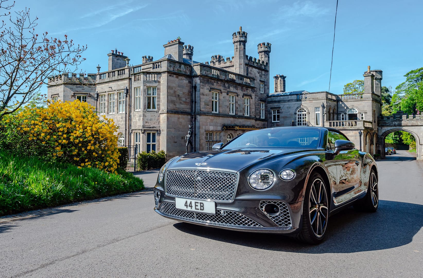 A black Bentley car driving up the road passed Bolesowrth Castle