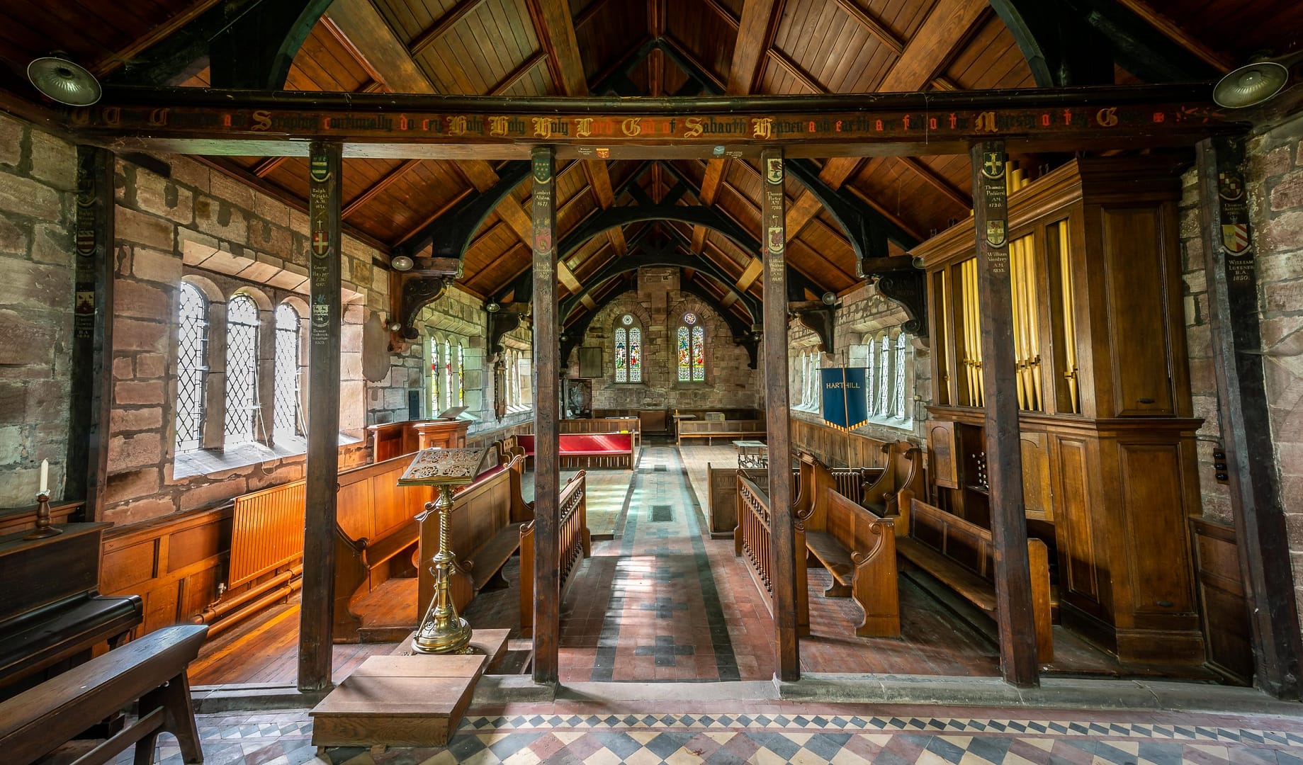 A beautifully preserved historic church with wooden pews, a grand organ, and intricate stained glass windows, offering a stunning film location. Located in Harthill, o the Bolesworth estate.