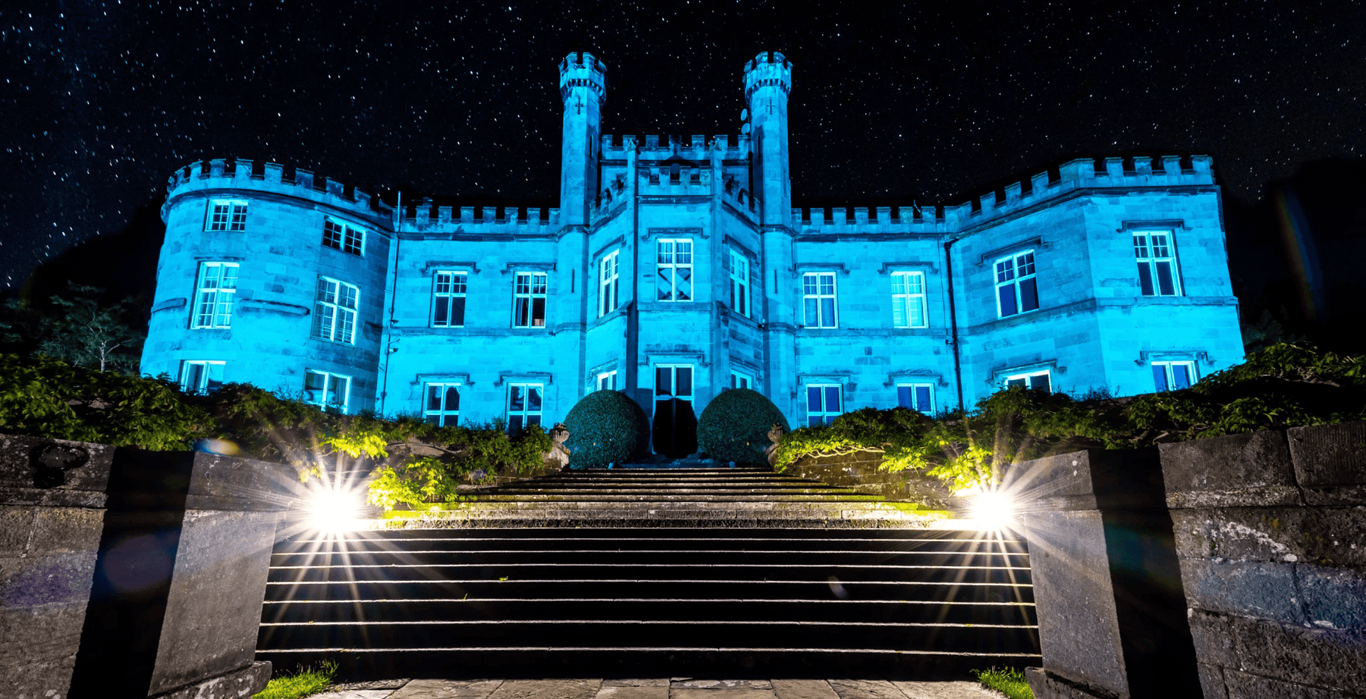 Bolesworth Castle lit up in blue
