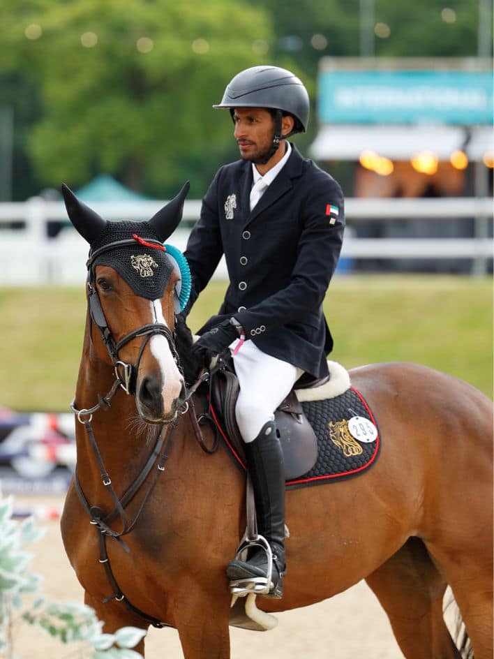 Winning Al Shira'aa equestrian rider and horse standing proudly after equestrian compeition.