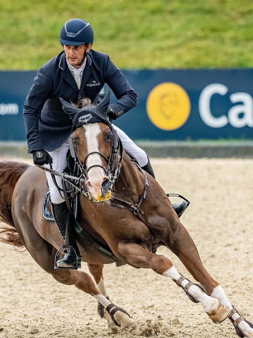 Rider and horse turning sharply in an arena with Cavago branding visible in the background during Bolesworth International.