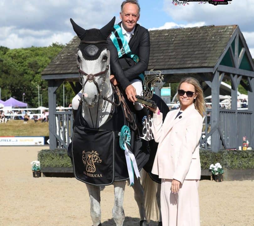 Lady providing an award for an Al-Shiraa'a equestrian rider.